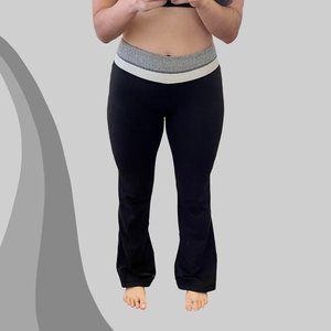 Black Lululemon flare yoga pants with grey herringbone and white waist band